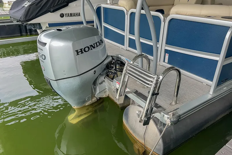 Slide: The Image of Premier 230 Sunsation 2020 pontoon boat with Honda outboard motor in water. - 26