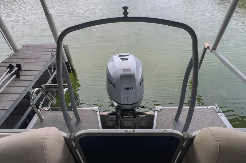 Slide: The Image of 2020 Premier 230 Sunsation pontoon boat with Honda 150 outboard motor at dock. - 23