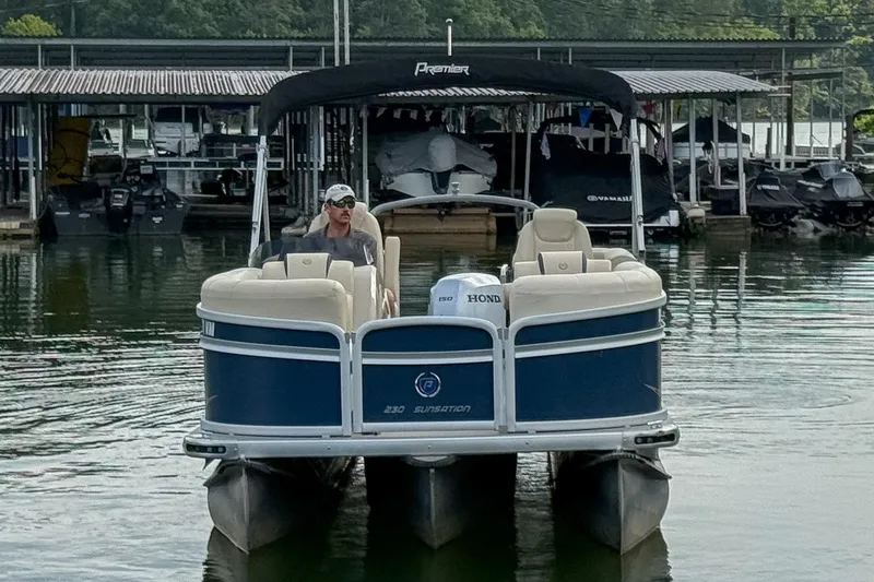 Slide: The Image of 2020 Premier 230 Sunsation pontoon boat on water near docks. - 16