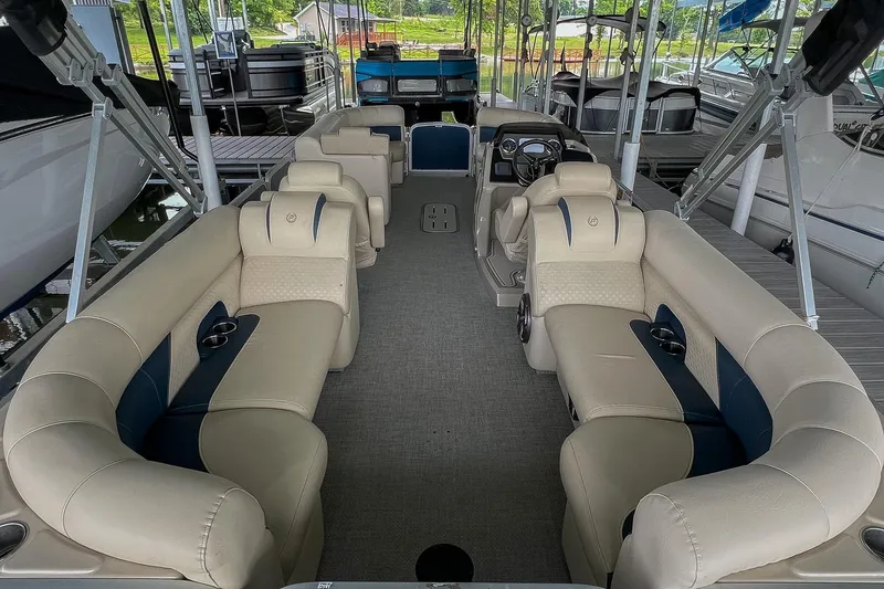 Slide: The Image of 2020 Premier 230 Sunsation pontoon boat interior with beige seating and modern dashboard. - 38