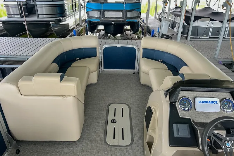 Slide: The Image of Interior of a 2020 Premier 230 Sunsation pontoon boat with plush seating and control panel. - 33