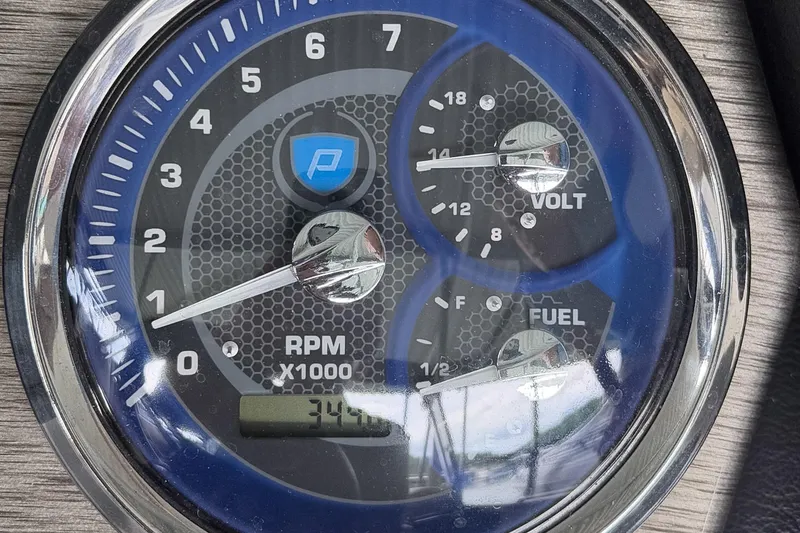 Slide: The Image of Close-up of 2020 Premier 230 Sunsation boat dashboard gauges displaying RPM, voltage, and fuel levels. - 22