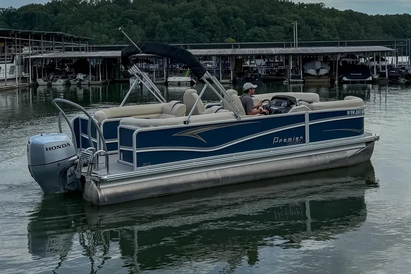 Slide: The Image of 2020 Premier 230 Sunsation pontoon boat with Honda motor on a calm lake. - 20