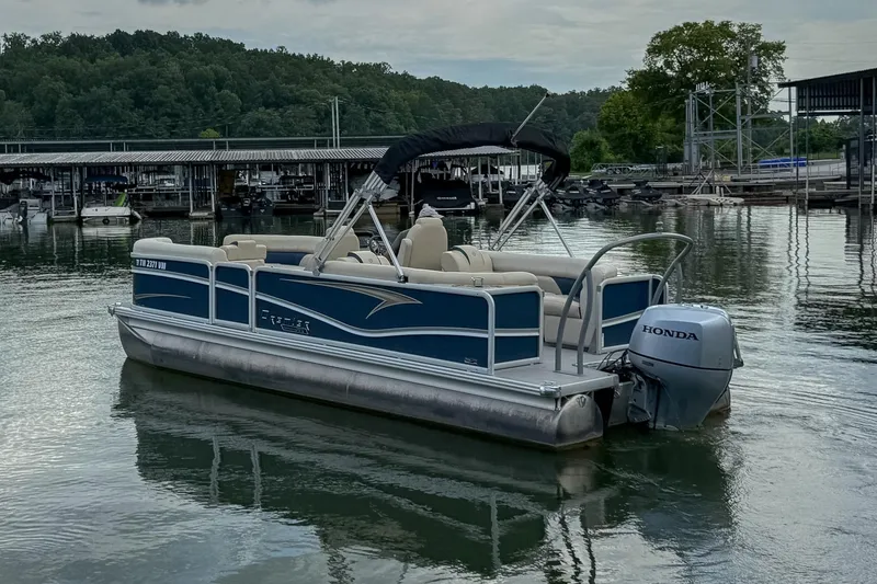 Slide: The Image of 2020 Premier 230 Sunsation pontoon boat with Honda motor on a calm lake. - 19