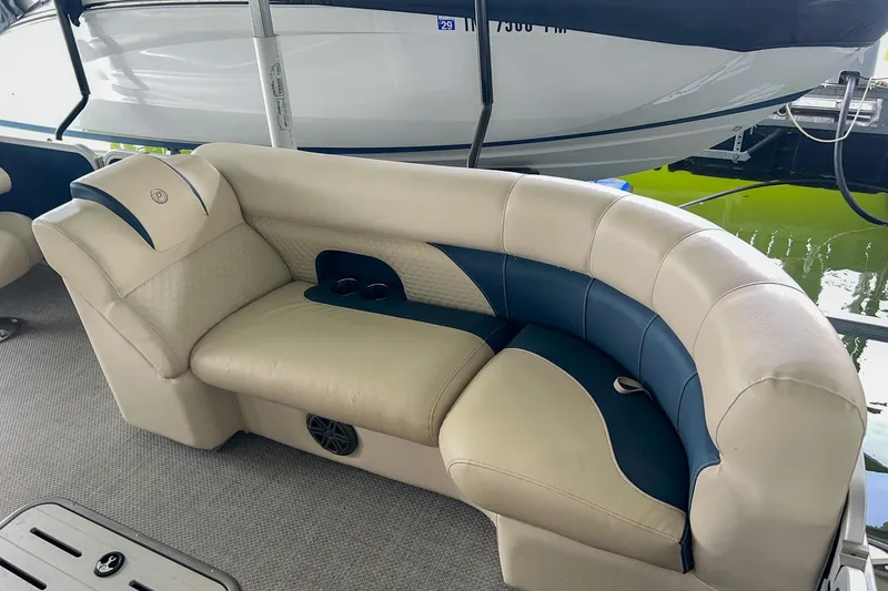 Slide: The Image of Luxurious seating on 2020 Premier 230 Sunsation pontoon boat, featuring beige and blue upholstery. - 30