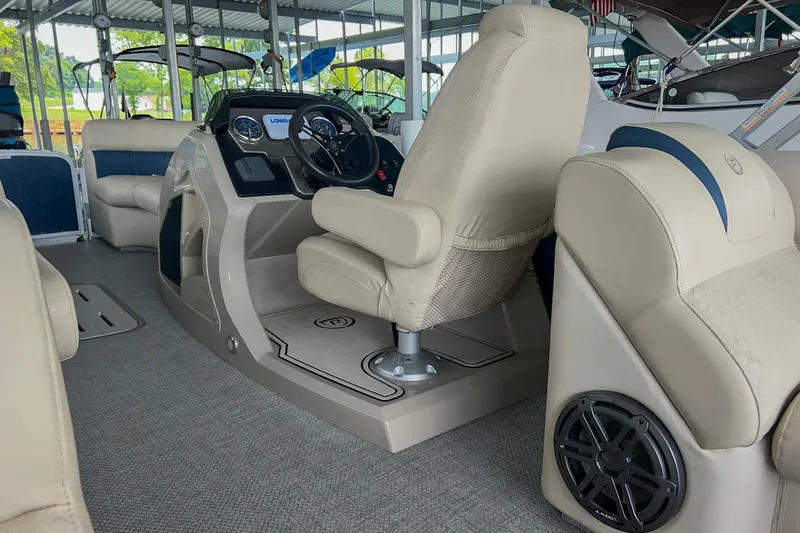 Slide: The Image of Interior of a 2020 Premier 230 Sunsation pontoon boat with beige seating and steering console. - 36