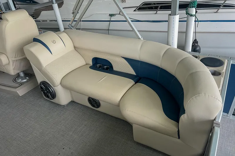 Slide: The Image of Luxurious seating on a 2020 Premier 230 Sunsation pontoon boat, featuring beige and blue upholstery. - 28