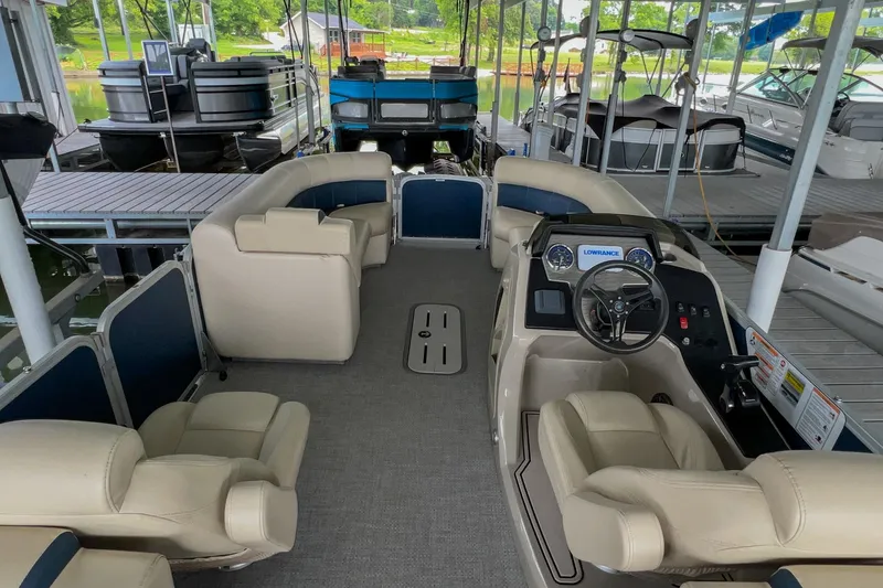 Slide: The Image of 2020 Premier 230 Sunsation pontoon boat interior with beige seating and steering console. - 37
