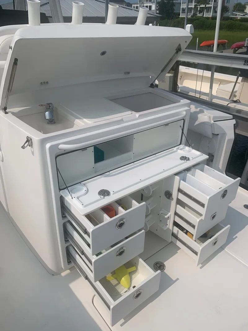 Slide: The Image of The image shows an open fishing station with multiple drawers and compartments on a boat. - 33