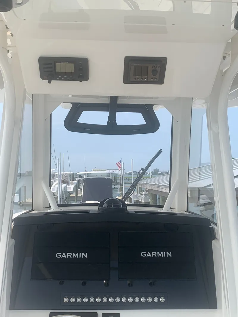 Slide: The Image of The image shows the cockpit of a 2020 Regulator 31 boat with Garmin electronics. - 42