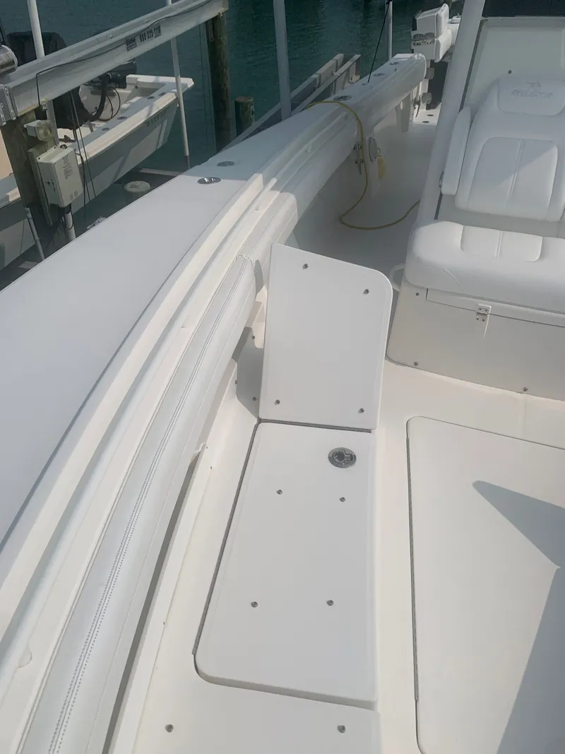Slide: The Image of The image shows the deck of a 2020 Regulator 31 boat with white upholstery. - 20