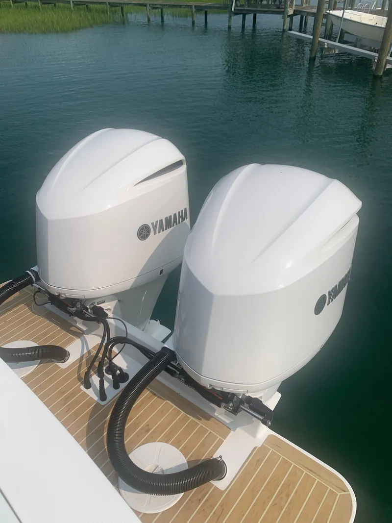 Slide: The Image of Two Yamaha outboard engines are mounted on a boat, resting on calm water. - 55