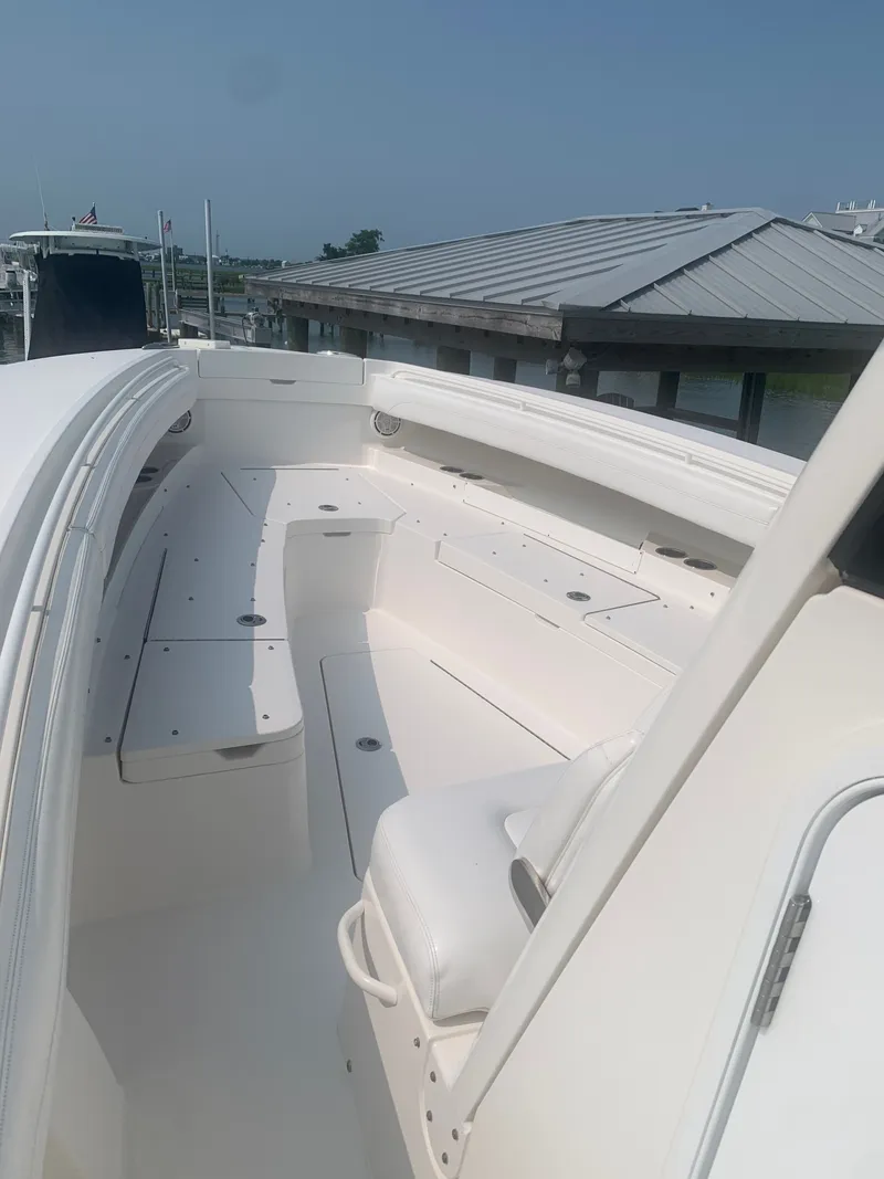 Slide: The Image of The image shows the deck of a 2020 Regulator 31 boat with white seating. - 39