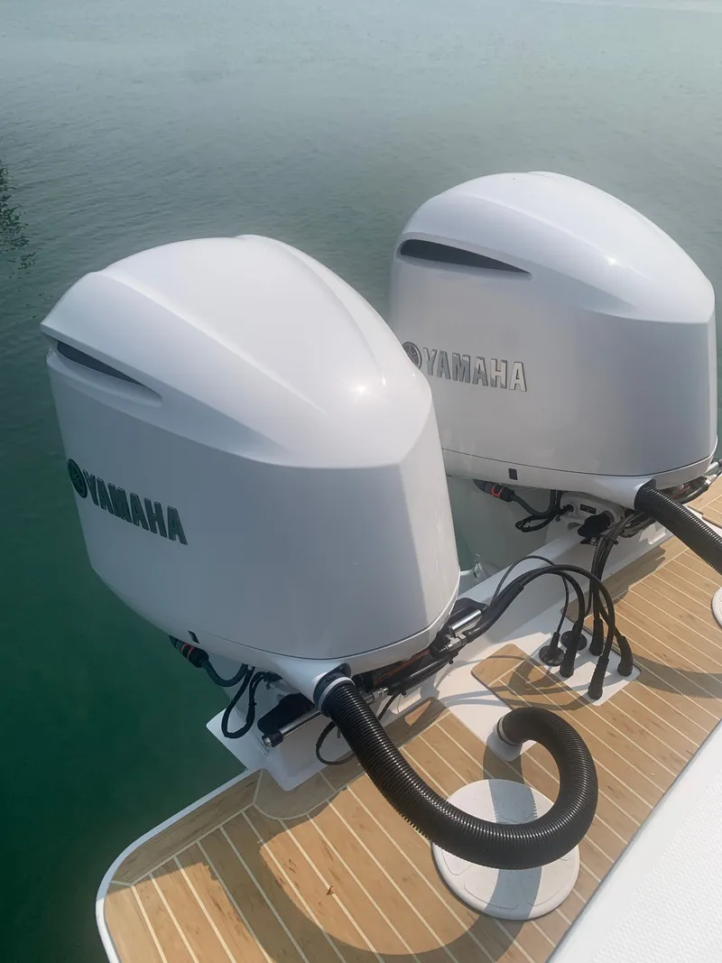 Slide: The Image of Two Yamaha outboard engines are mounted on a boat, resting on calm water. - 36