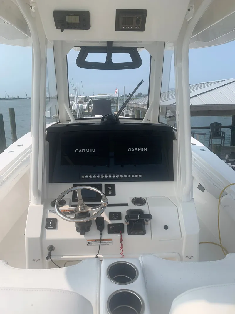 Slide: The Image of The image shows the cockpit of a 2020 Regulator 31 boat with dual Garmin screens. - 41