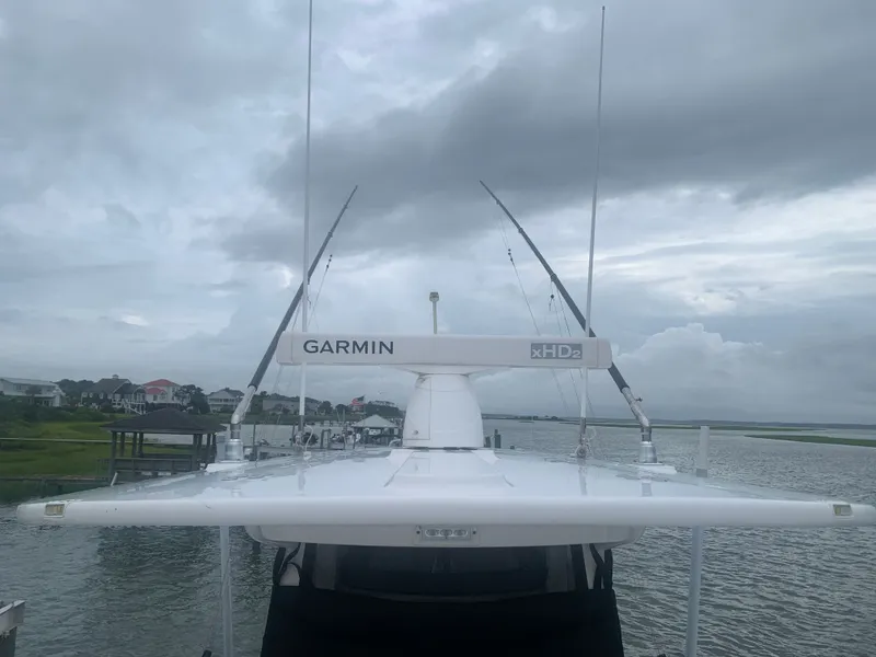 Slide: The Image of A 2020 Regulator 31 boat with Garmin xHD2 radar on the roof, set against a cloudy coastal backdrop. - 18