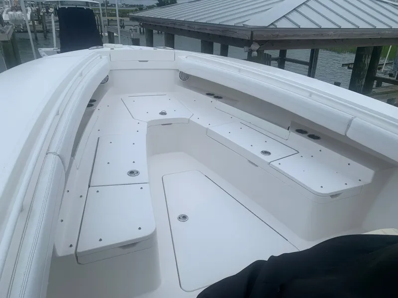 Slide: The Image of The image shows the bow of a 2020 Regulator 31 boat with white seating and storage. - 5
