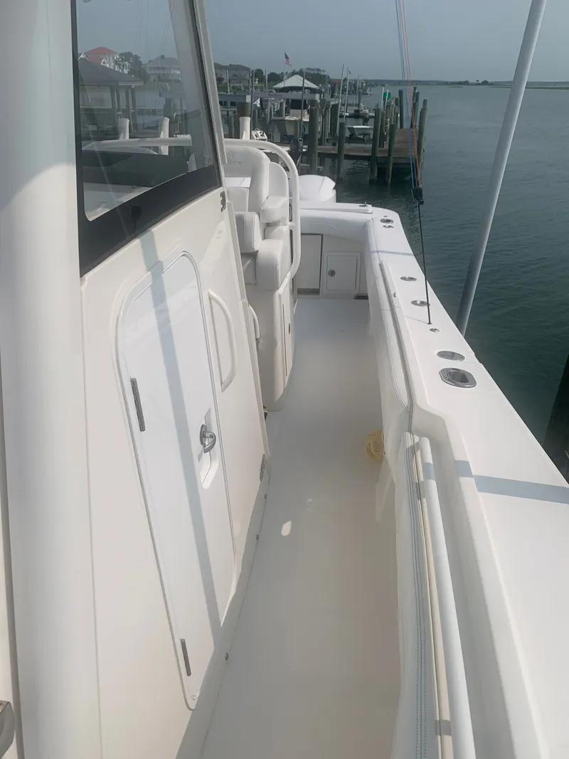 Slide: The Image of The image shows the deck of a 2020 Regulator 31 boat docked at a pier. - 26