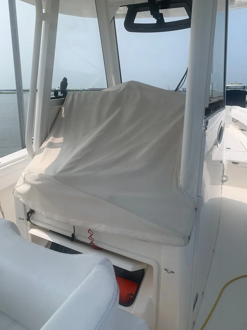 Slide: The Image of The image shows the cockpit of a 2020 Regulator 31 boat with a covered helm console. - 44