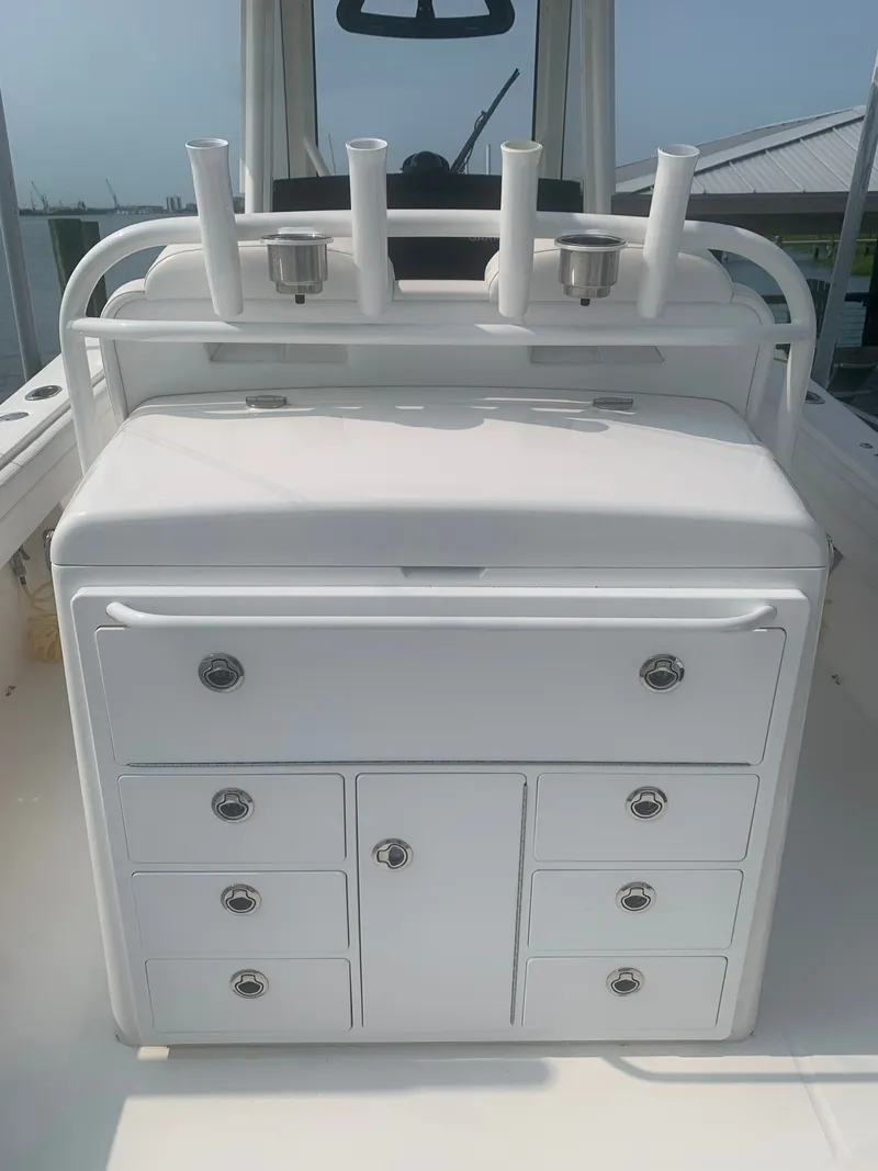 Slide: The Image of The image shows the cockpit of a 2020 Regulator 31 with multiple drawers and rod holders. - 53