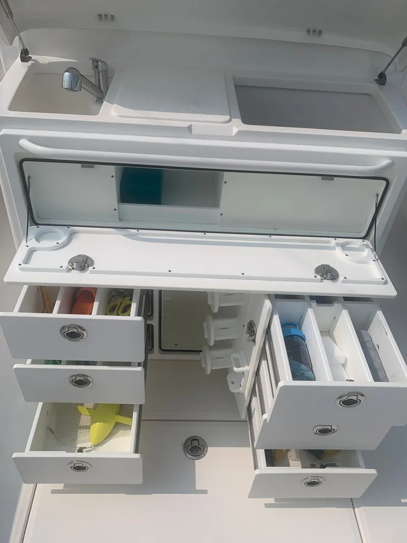 Slide: The Image of The 2020 Regulator 31 features a well-organized galley area with multiple drawers and a sink. - 31