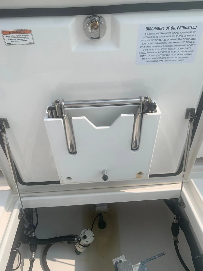Slide: The Image of A storage compartment inside a 2020 Regulator 31 boat with hydraulic arms. - 29