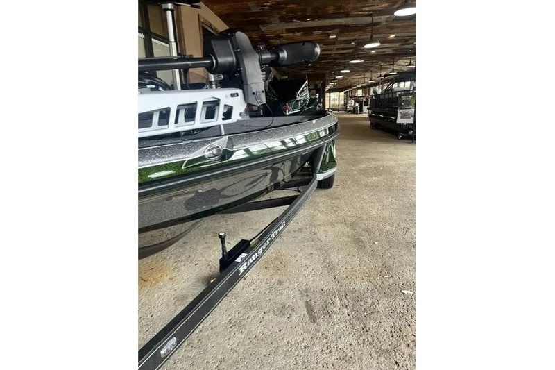 Slide: The Image of 2026 Ranger Z520 boat on trailer in a rustic indoor setting. - 2