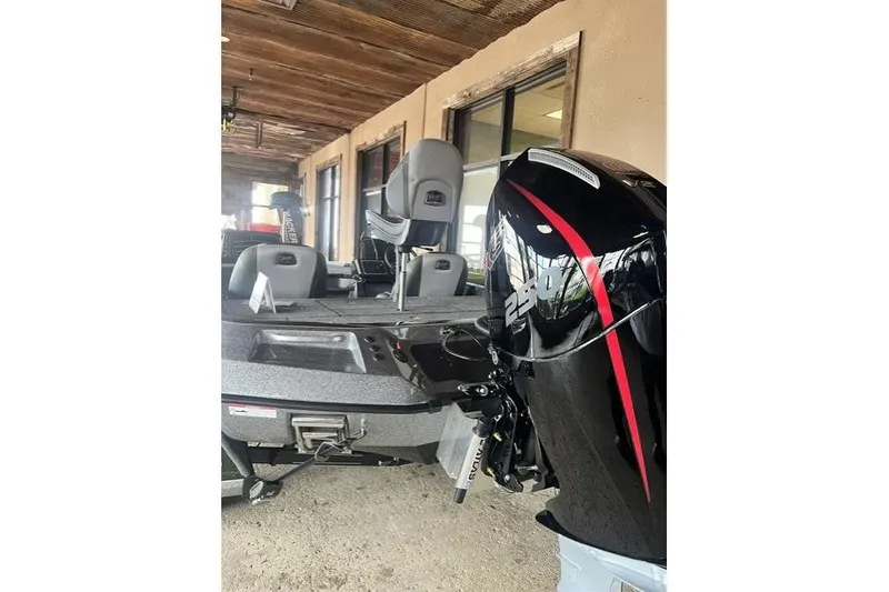 Slide: The Image of 2026 Ranger Z520 boat with powerful engine and seating, displayed under rustic wooden roof. - 7