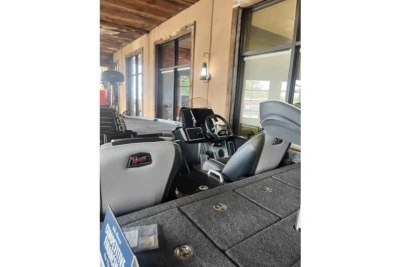Slide: The Image of 2026 Ranger Z520 boat interior with modern dashboard and seating, displayed indoors. - 6