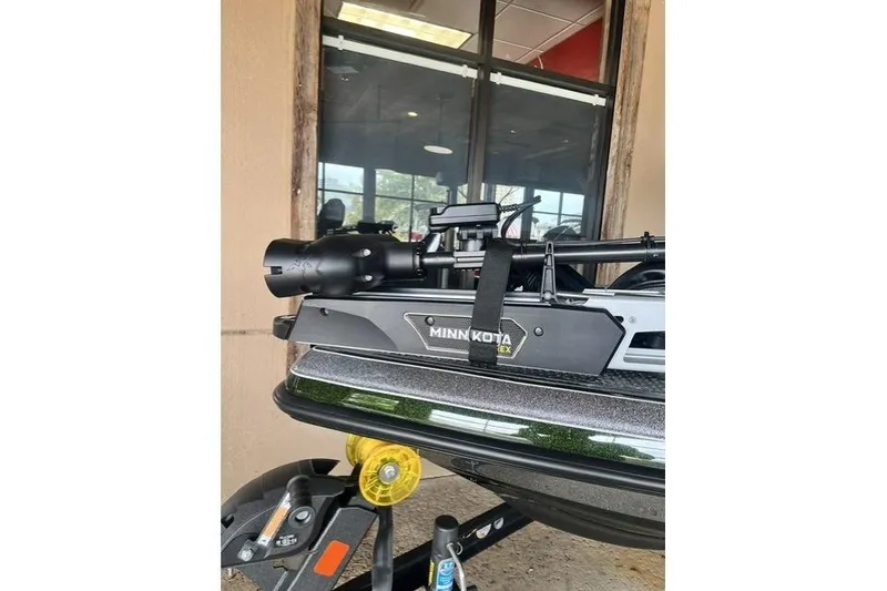 Slide: The Image of 2026 Ranger Z520 boat with Minn Kota trolling motor, parked outside a building. - 9