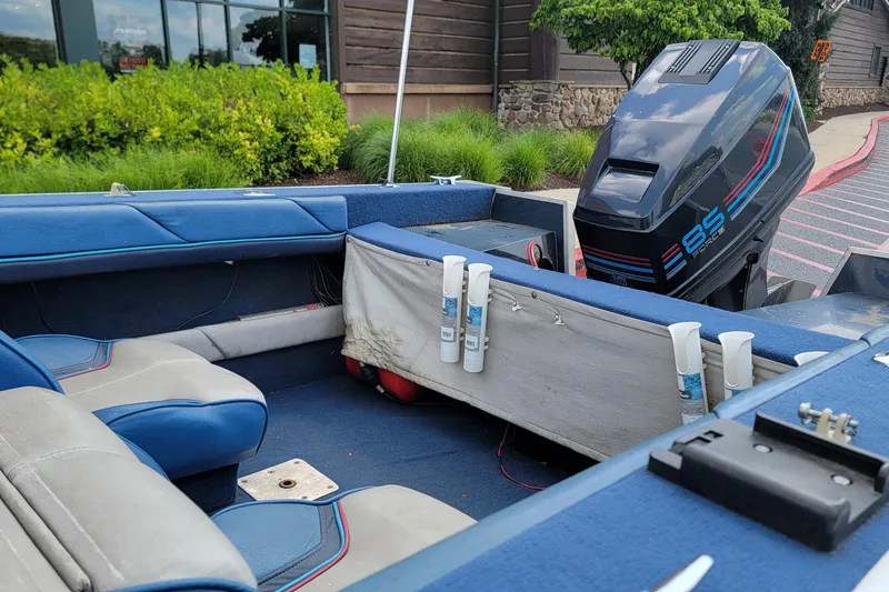 Slide: The Image of Interior of a 1988 BLUE FINN SPORTSMAN 1700 boat with blue seating and an outboard motor. - 5