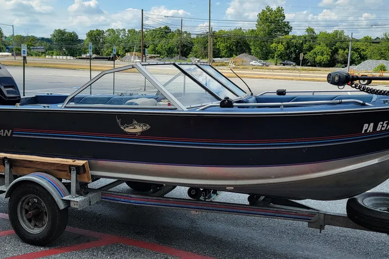 Slide: The Image of 1988 BLUE FINN SPORTSMAN 1700 boat on trailer in parking lot. - 8