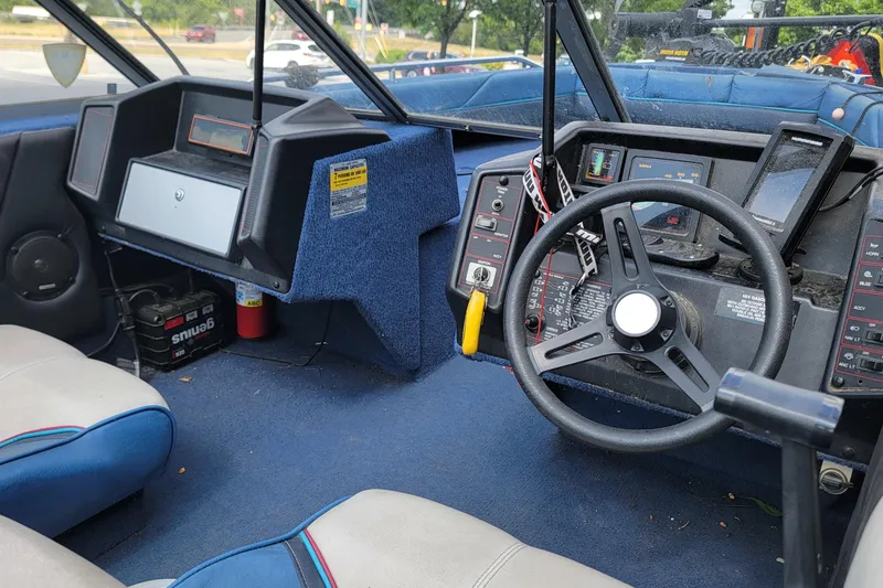 Slide: The Image of Interior of a 1988 BLUE FINN SPORTSMAN 1700 boat, featuring steering wheel and dashboard controls. - 10