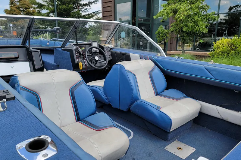 Slide: The Image of 1988 BLUE FINN SPORTSMAN 1700 boat interior with blue and white seating, steering wheel, and dashboard. - 4