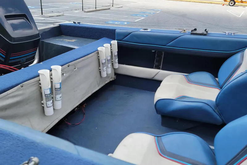 Slide: The Image of Interior of a 1988 BLUE FINN SPORTSMAN 1700 boat with blue and white seating. - 9