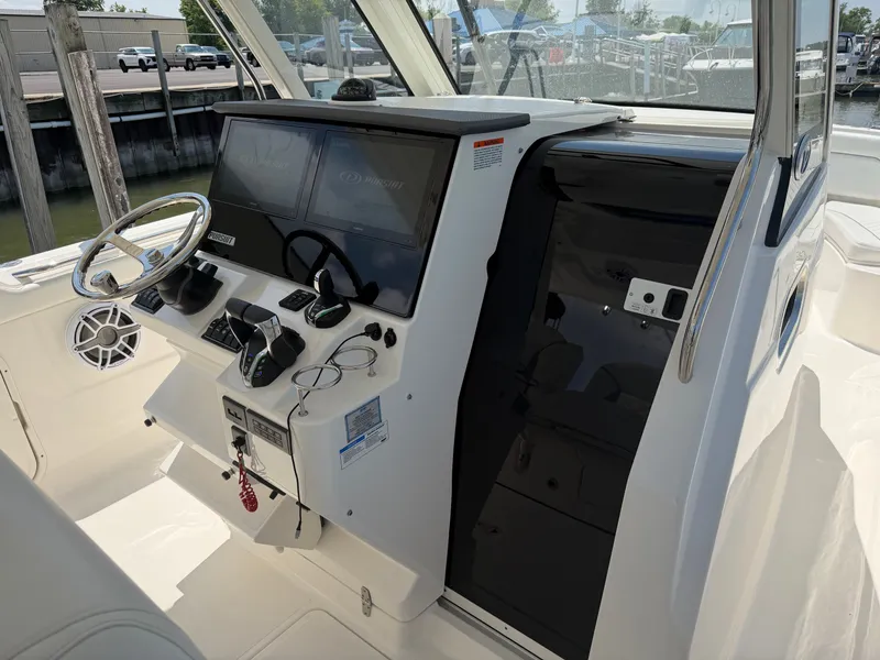 Slide: The Image of The image shows the cockpit of a 2025 Pursuit S 328 Sport boat with modern controls. - 17