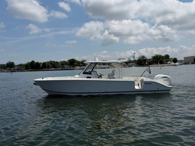 Slide: The Image of A white 2025 Pursuit S 328 Sport boat floats on calm water under a cloudy sky. - 3