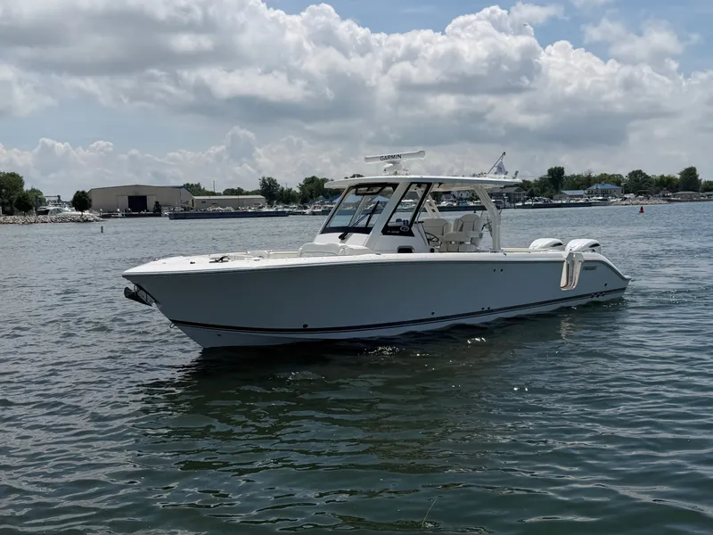 Slide: The Image of A sleek, modern boat on calm water with a spacious deck and protective canopy. - 2