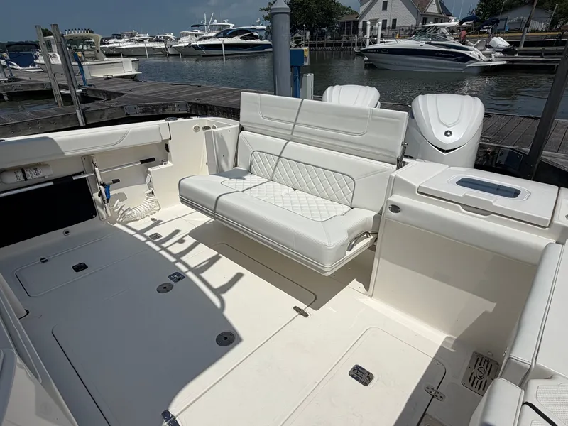 Slide: The Image of The image shows the cockpit of a 2025 Pursuit S 328 Sport with white upholstery. - 10