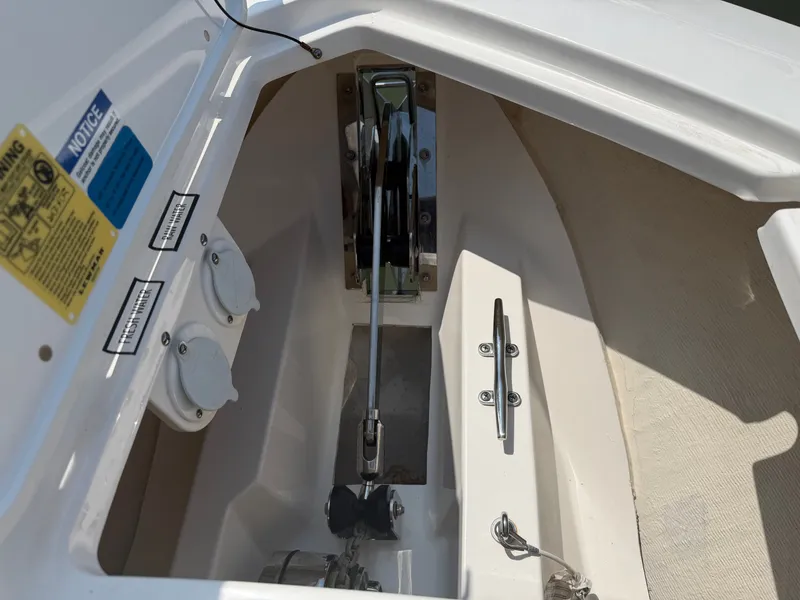 Slide: The Image of The anchor locker of a 2025 Pursuit S 328 Sport with windlass and fittings. - 26