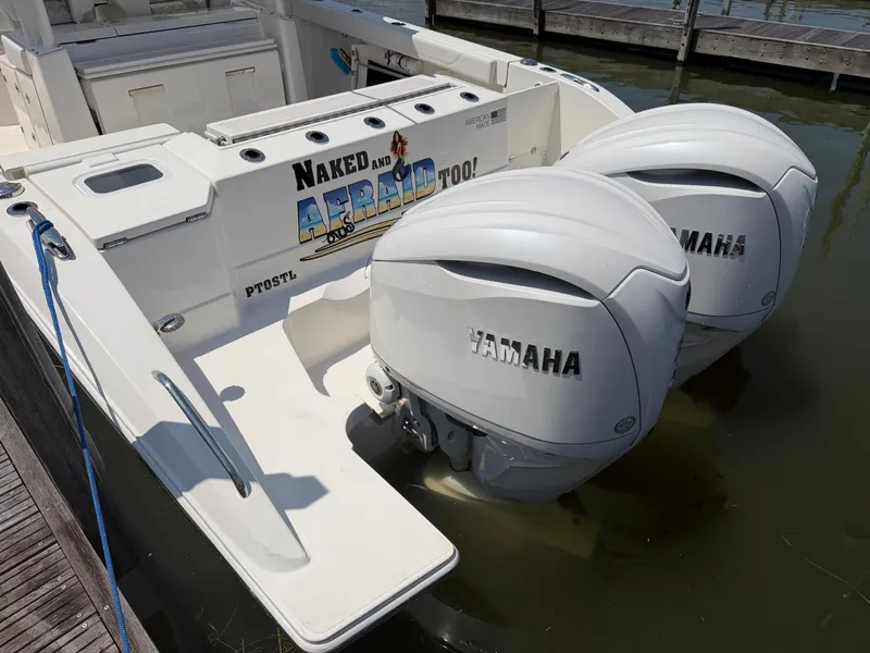 Slide: The Image of A 2025 Pursuit S 328 Sport with twin Yamaha outboard engines, docked at a pier. - 6