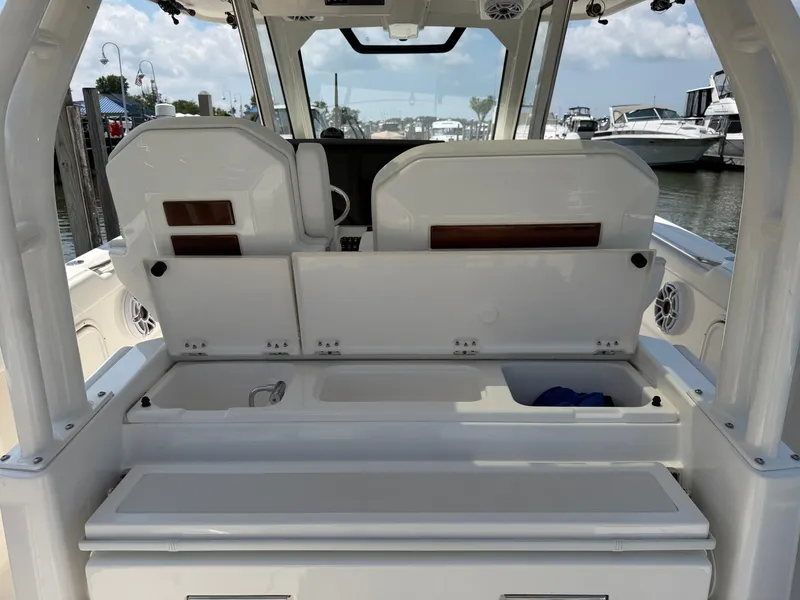 Slide: The Image of The image shows the cockpit of a 2025 Pursuit S 328 Sport with storage and seating. - 13