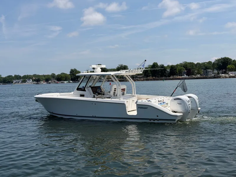 Slide: The Image of A 2025 Pursuit S 328 Sport on calm water with twin outboard engines. - 4
