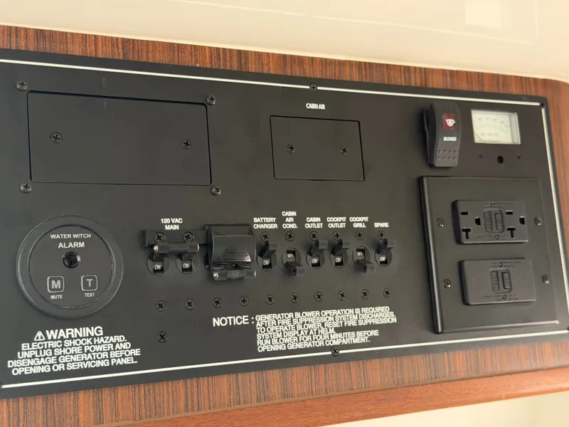 Slide: The Image of Electrical control panel with switches and warning labels on wood paneling. - 32