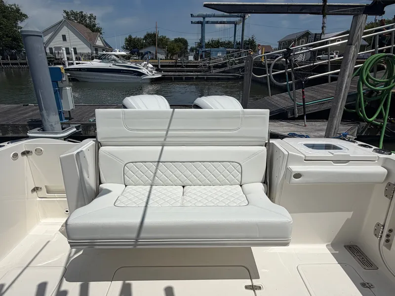 Slide: The Image of The 2025 Pursuit S 328 Sport features a luxurious white bench seat in the open cockpit area. - 9