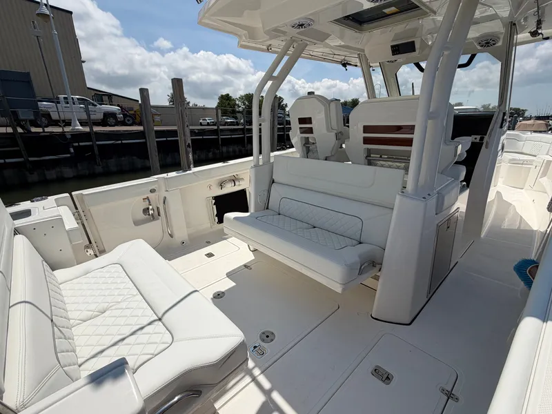 Slide: The Image of The image shows the cockpit of a 2025 Pursuit S 328 Sport with white upholstered seating. - 12