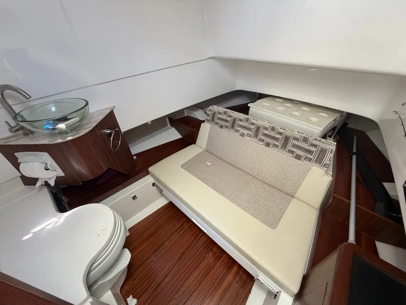 Slide: The Image of Interior of a 2025 Pursuit S 328 Sport with seating, a sink, and a toilet. - 31
