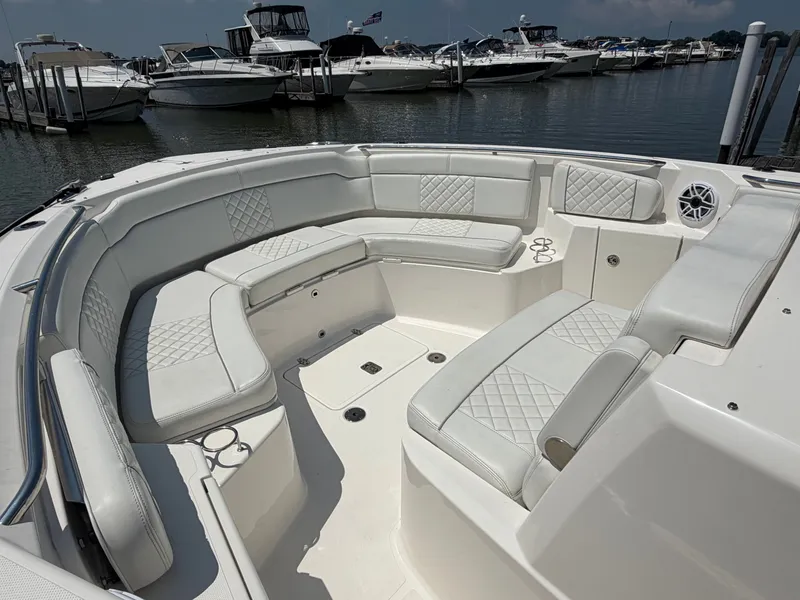 Slide: The Image of The image shows the spacious cockpit of a 2025 Pursuit S 328 Sport with white upholstery. - 22