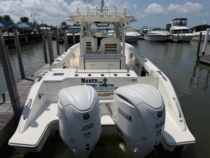 Slide: The Image of A 2025 Pursuit S 328 Sport boat docked. It features twin Yamaha engines. - 5