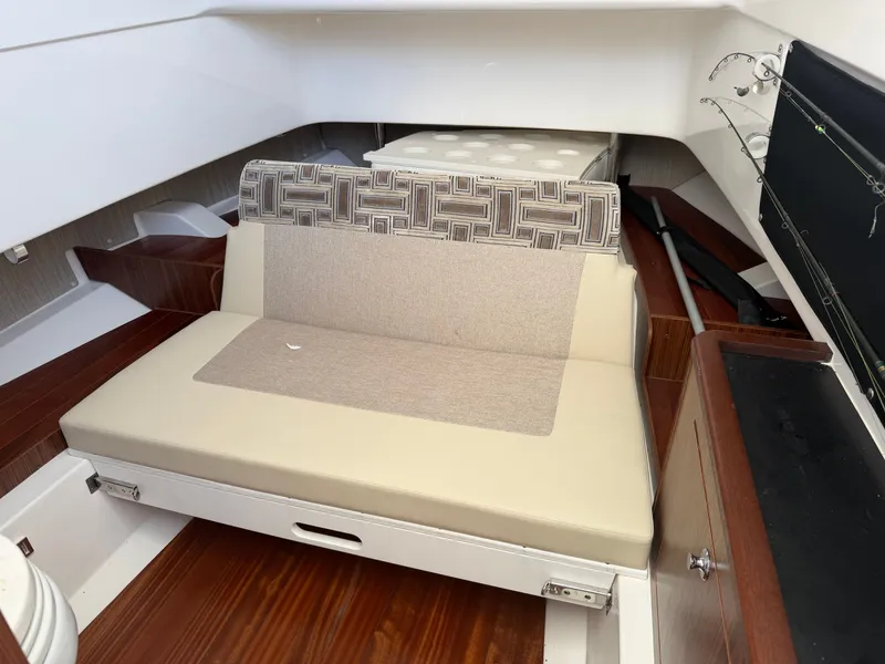 Slide: The Image of Interior of a 2025 Pursuit S 328 Sport with cushioned seating and wooden flooring. - 30